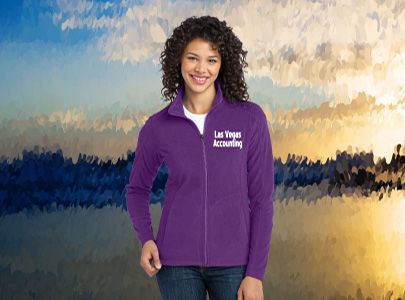 Woman wearing a purple, light weight, zippered jacket decorated with Las Vegas Accounting logo for those cool Las Vegas evenings in the winter months.