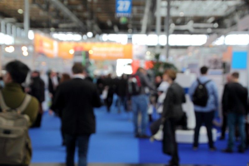 blurry image of people at a trade show